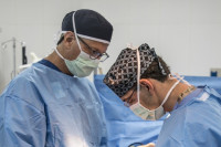 Michael Behr, MD and Peter Symbas, MD perform surgery