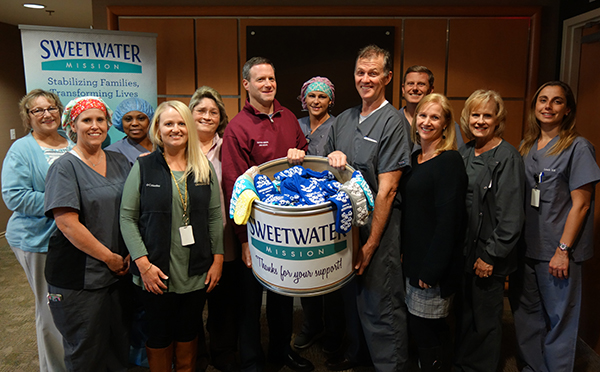 OrthoAtlanta sock donation to Sweetwater Mission